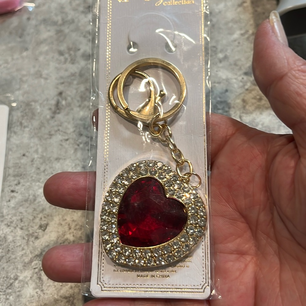 Bag Charm/Keychain it’s a heart with red and crystal in the outside